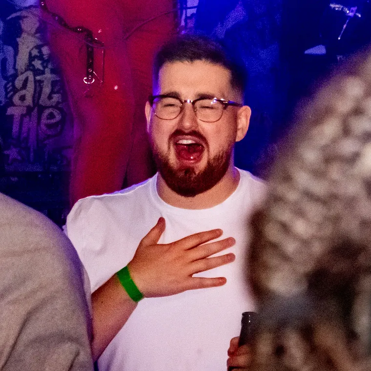 A man mid shout with his hand on his chest, knowing every word
